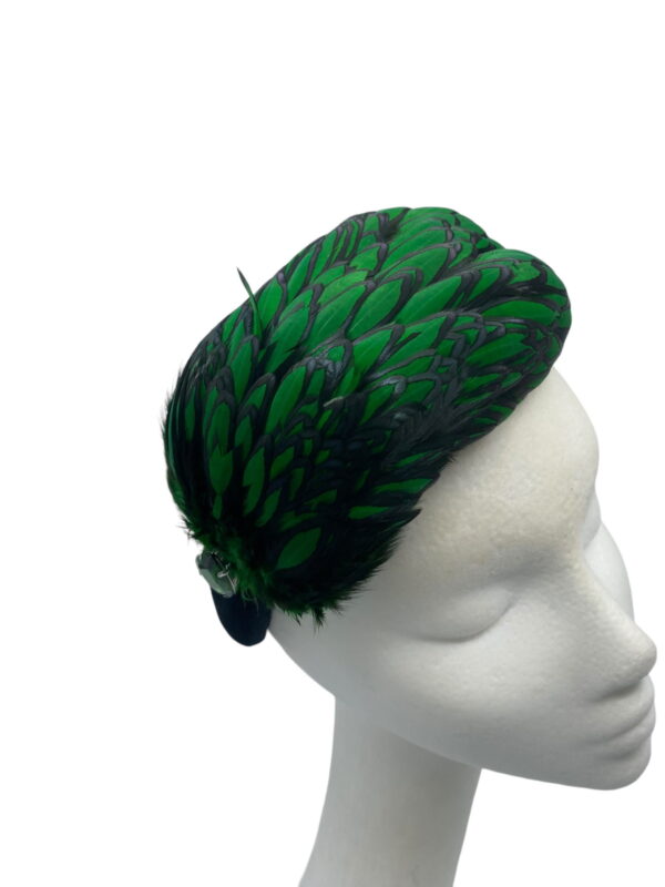 Stunning emerald green and black feather crown with little jewel detail to finish.